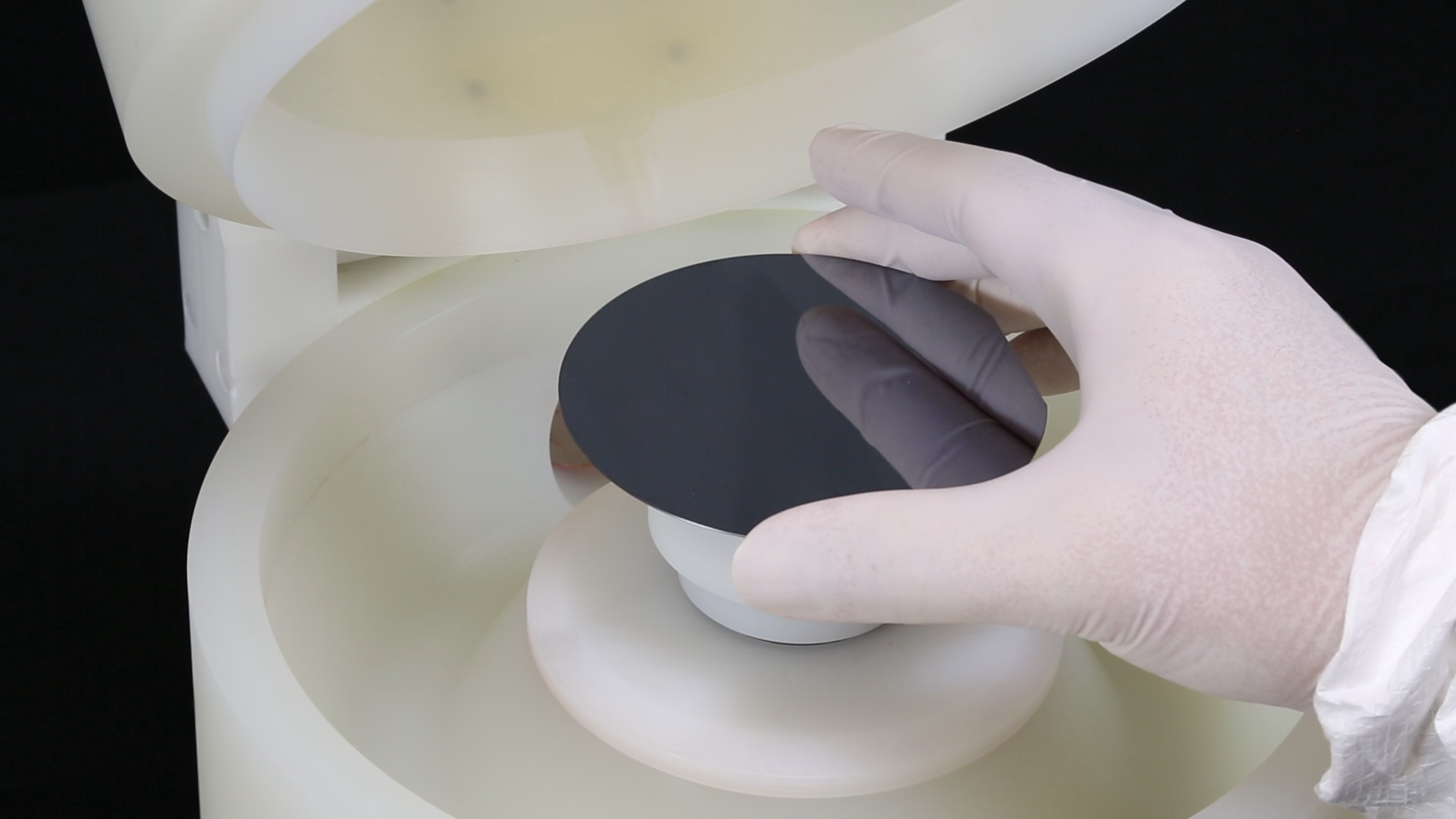 Placing a wafer on a spin coater chuck Placing a wafer on to the spin coater chuck